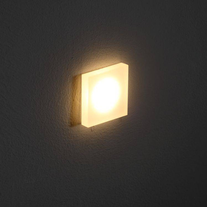 square LED plinth light mounted in a grey wall
