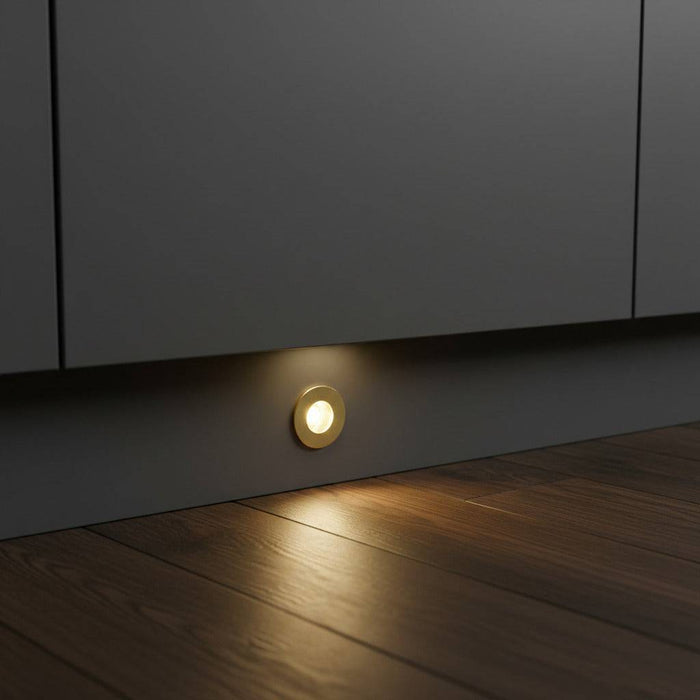 gold kitchen plinth light installed at low level in a grey kitchen kickboard