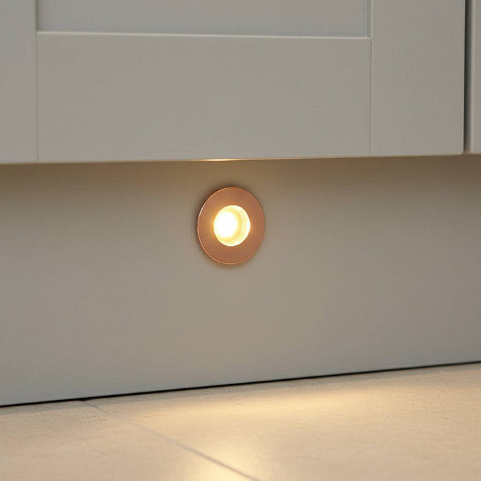 rose gold kitchen kickboard light installed in a white kitchen kickboard