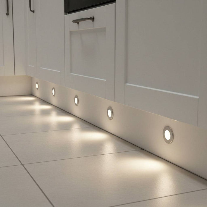 white LED plinth lights mounted along the white low level plinth in a kitchen