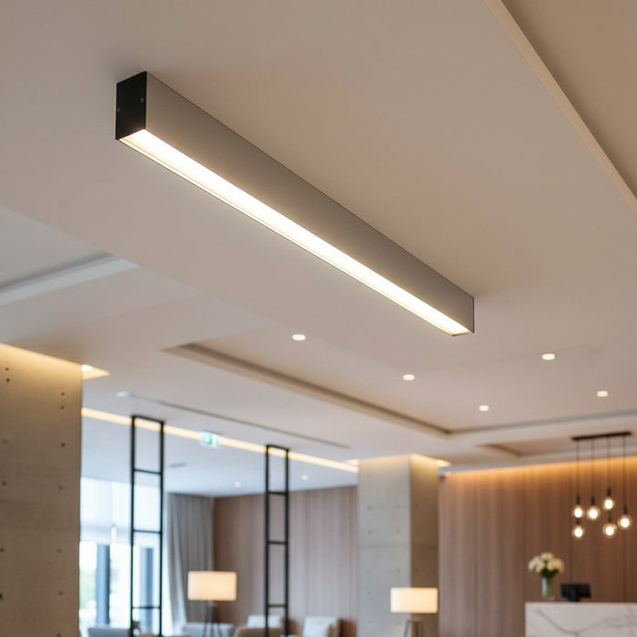 silver slim surface downlight mounted on the ceiling in a hotel reception