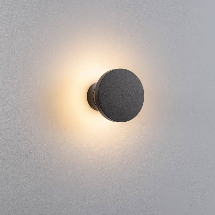 black exterior wall mount light shown fitted on a white wall