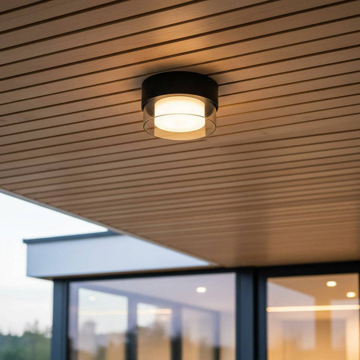 black outdoor ceiling light fixture mounted on a wooden ceiling outdoors