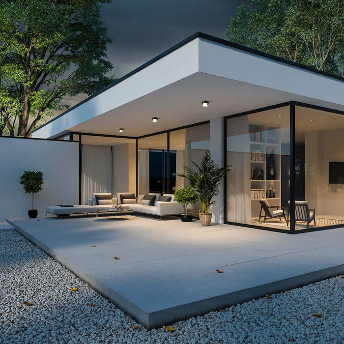 black outdoor ceiling light fixture mounted under the canopy of a modern home
