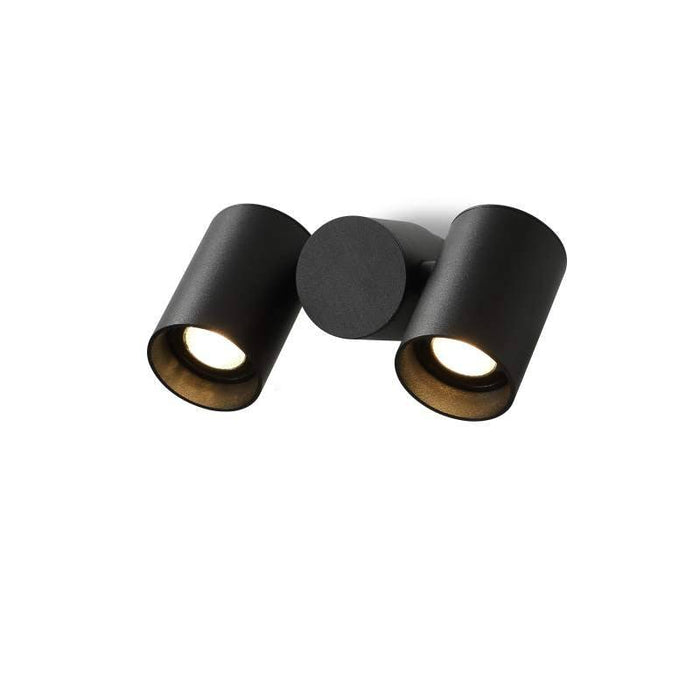 black outdoor wall spotlight shown mounted on a white wall