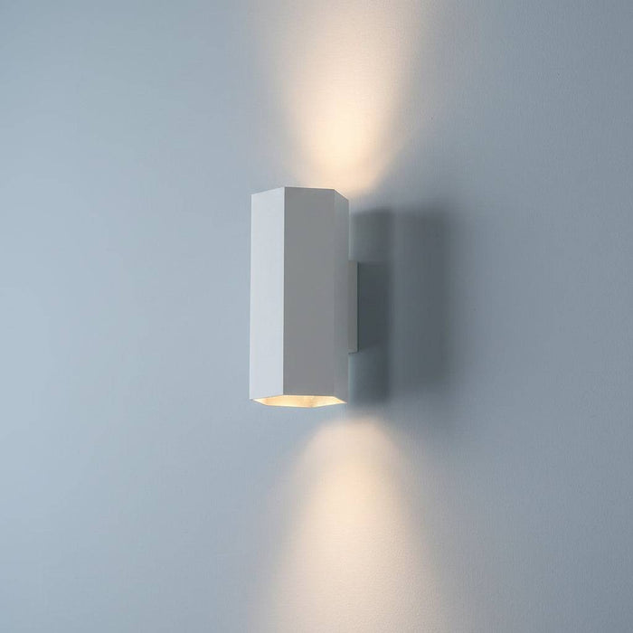 White interior up and down wall light on  a pale blue coloured wall