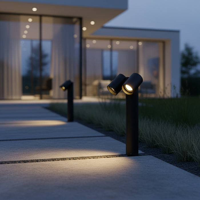 black twin head LED adjustable bollard light mounted alongside a pathway