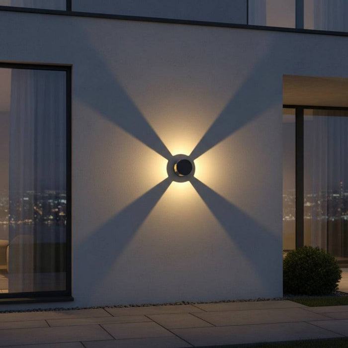 black outside wall light mounted on the exterior wall of a home in between 2 large windows