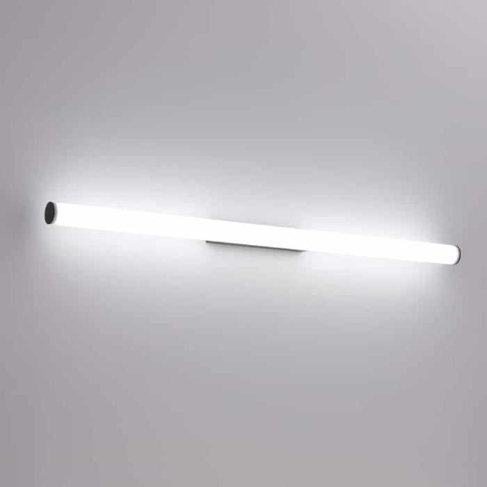 black tubular bathroom sconce mounted on a white wall