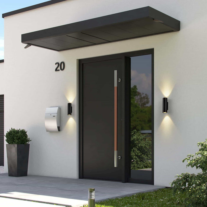 black outside up and down light mounted either side of the entrance door of a modern home