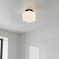 IP65 bathroom ceiling light mounted on a grey ceiling in a bathroom