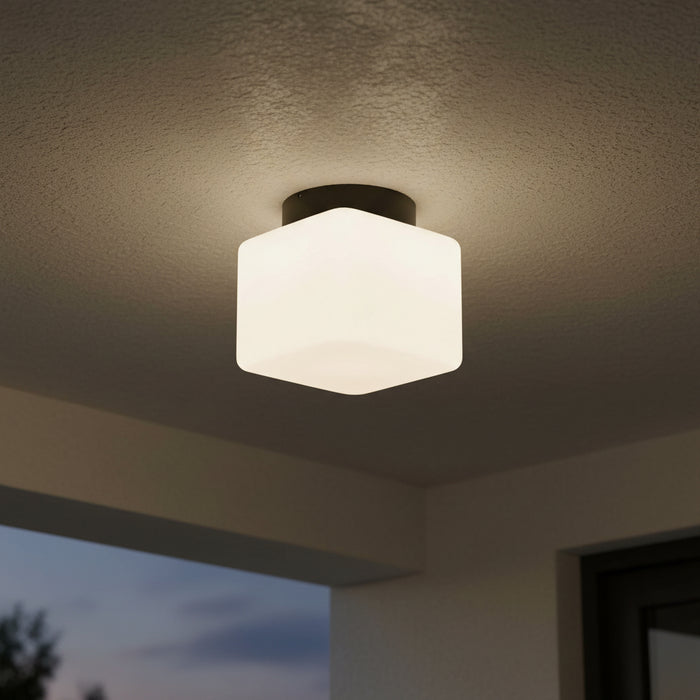 square outdoor ceiling light mounted on a porch ceiling at night