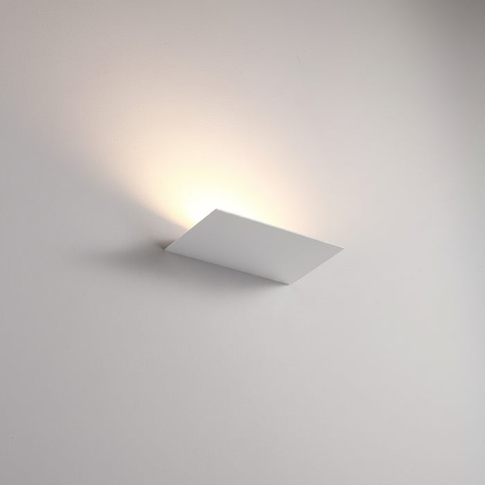 White indoor uplight wall light mounted on a white wall