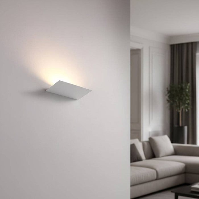 White indoor upplight wall light on  a light background in a lounge of a modern home