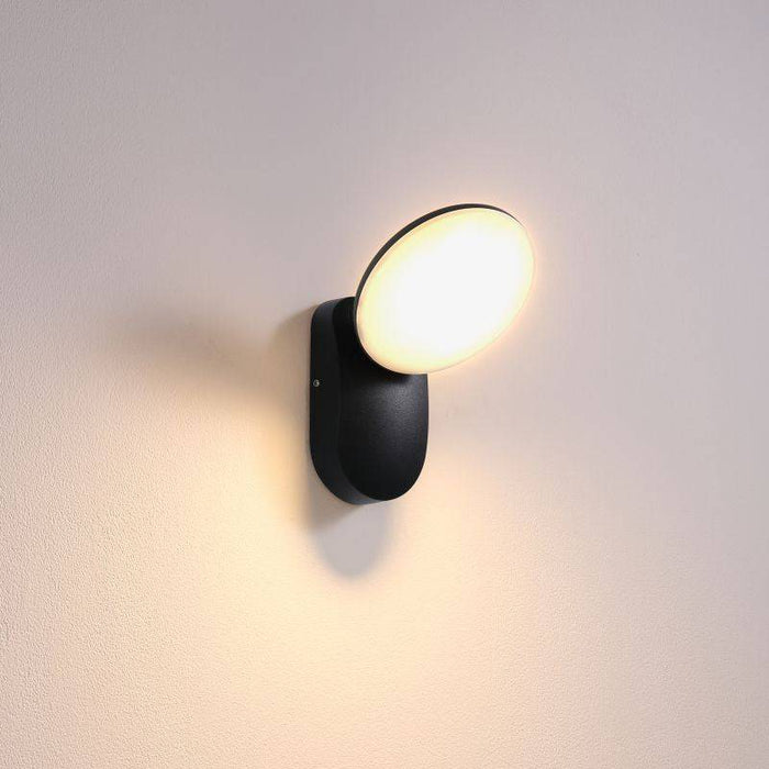 black outside house wall light shown mounted on a white wall