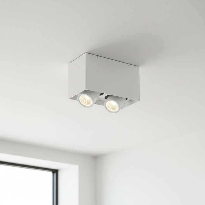 white adjustable LED ceiling light fixture mounted on a white ceiling in a modern house