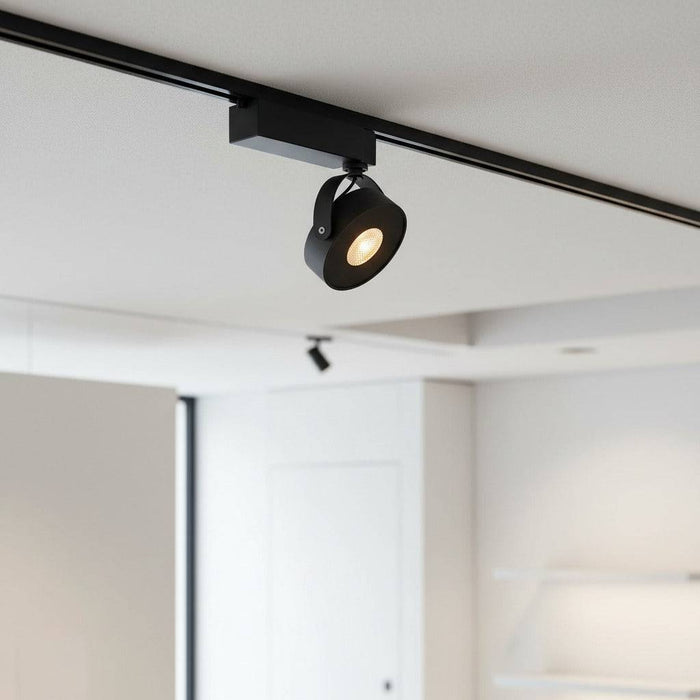 black track lighting fitting mounted on the ceiling in an office