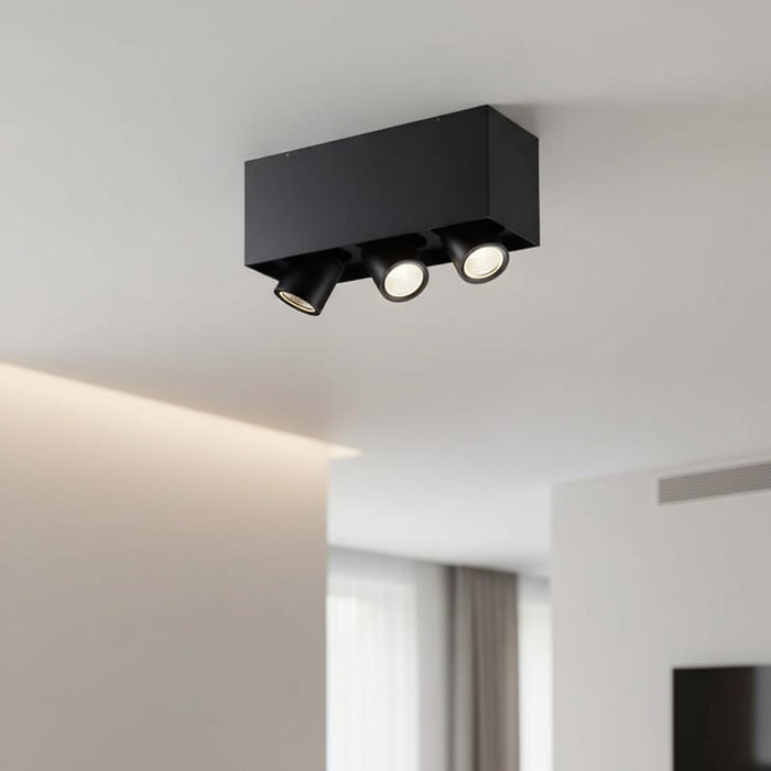 black surface mounted adjustable spotlight installed in a modern hotel room