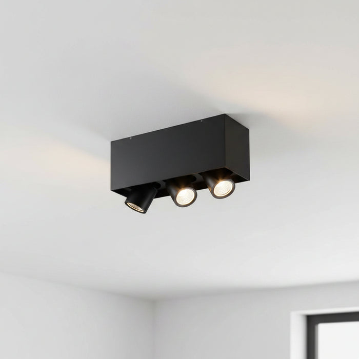 black surface mounted adjustable spotlight fitting on the ceiling in a modern home