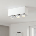 white surface mounted tiltable downlight mounted on the ceiling in a modern home