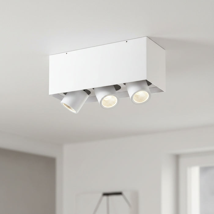 white surface mounted tiltable downlight mounted on the ceiling in a modern home