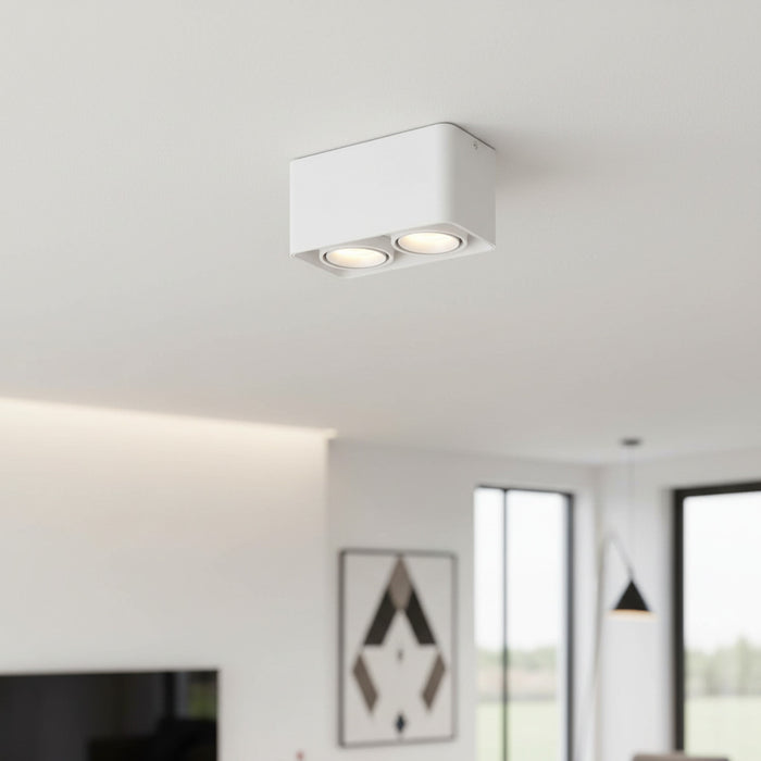 white flush ceiling light fitting mounted on a white ceiling in a modern home