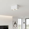 white flush ceiling light fitting mounted on a white ceiling in a modern home