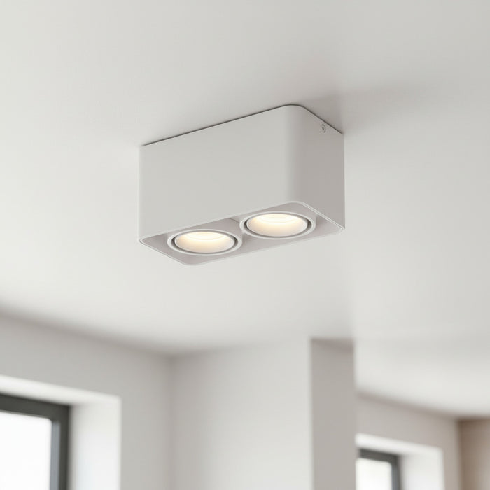 white flush ceiling light fitting mounted on a white ceiling in a kitchen