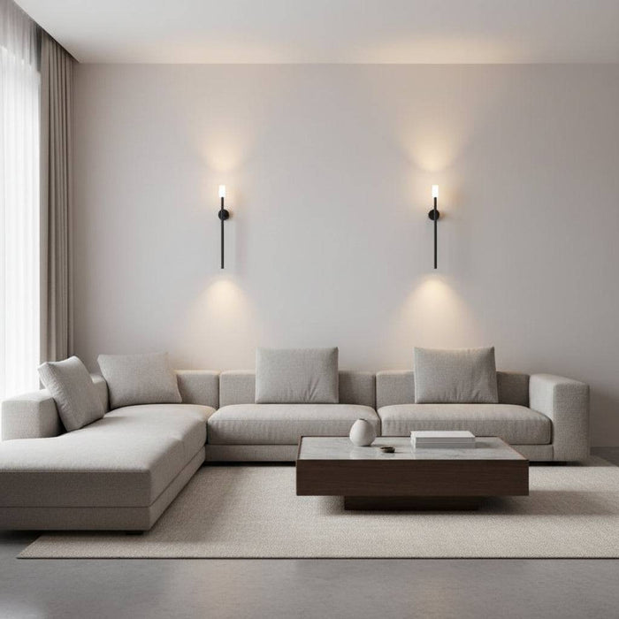Black up down wall light indoor two lights on a plain wall above a corner sofa and coffee table