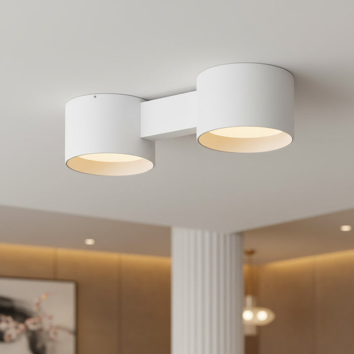 white flush ceiling light fixture mounted on the ceiling of a hotel reception