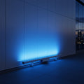 blue LED linear wall grazer lighting up the exterior of a commercial building