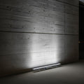cool white linear wall washer shining up a concrete wall