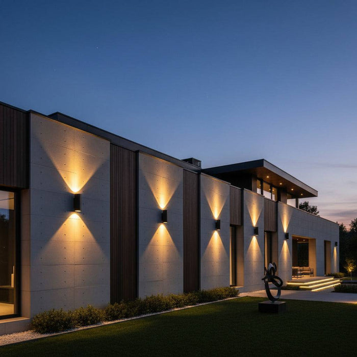 black large outdoor wall light mounted in a line along the exterior wall of a large modern home