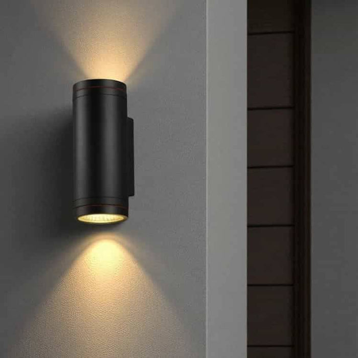 black large outdoor wall light installed on a white wall outside a modern house