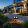 black twin garden spike light fitted in the garden outside a modern building