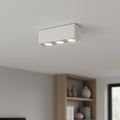 white surface mount spotlights installed on a white ceiling in a home