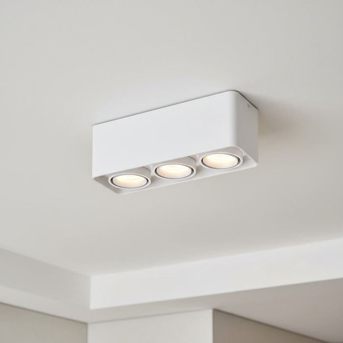 white surface mount spotlights mounted on the ceiling of a hotel room
