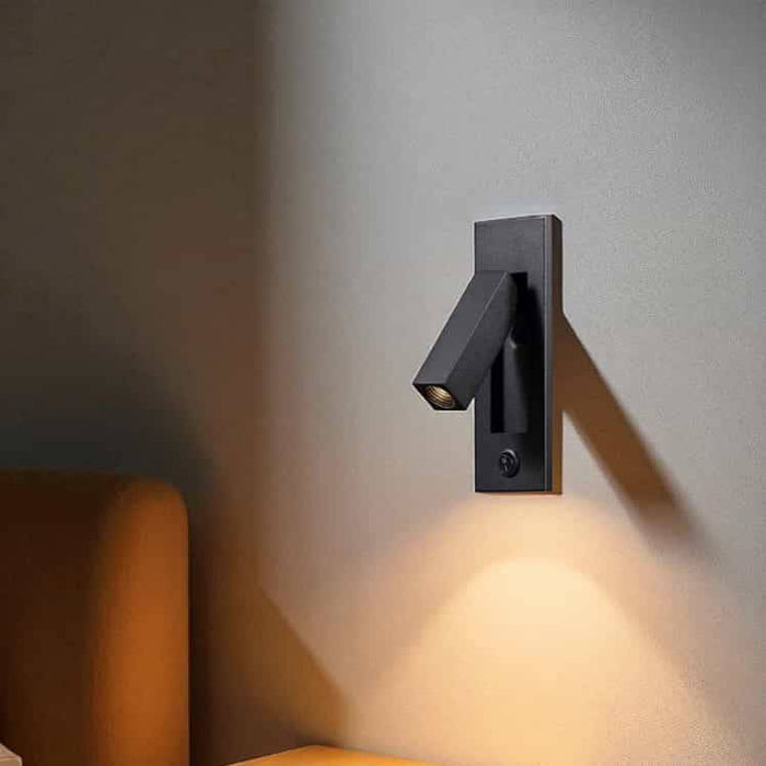 black recessed bedroom reading light mounted on the wall next to a bed
