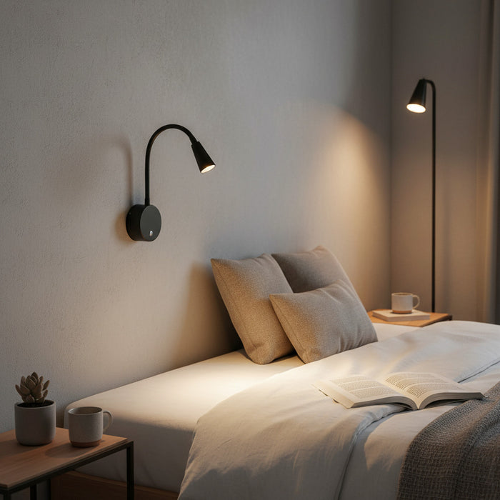 black dimmable bedside reading light mounted on a wall over a bed