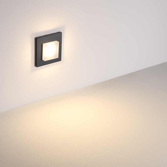 black low level recessed wall light mounted on a white wall