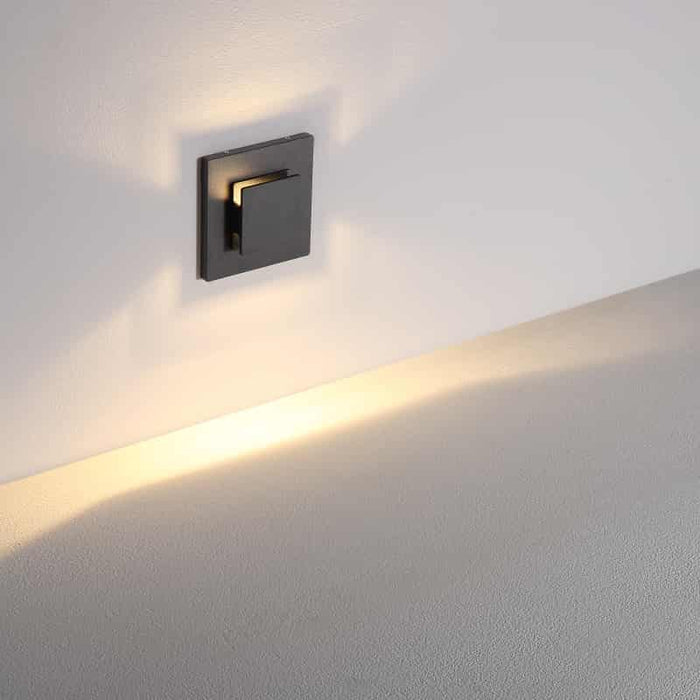 black recessed outdoor wall light mounted on a white wall