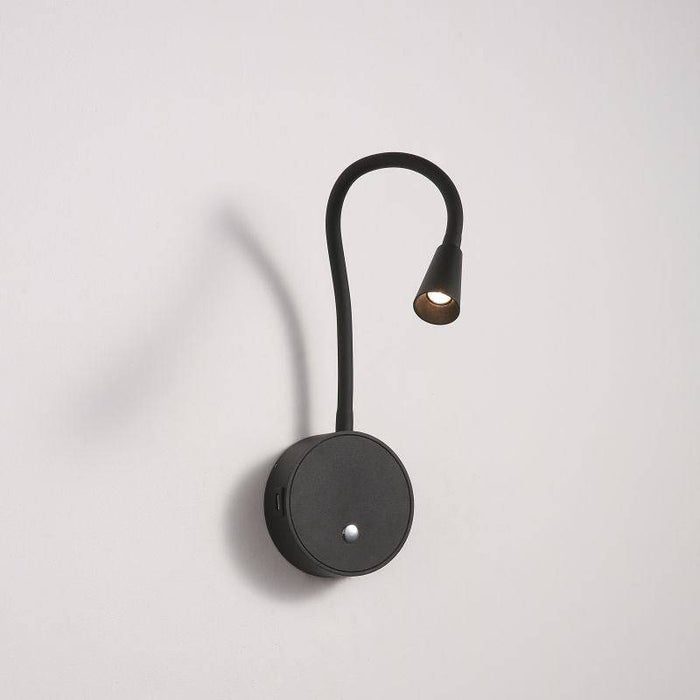black flexible LED reading light installed on a white wall