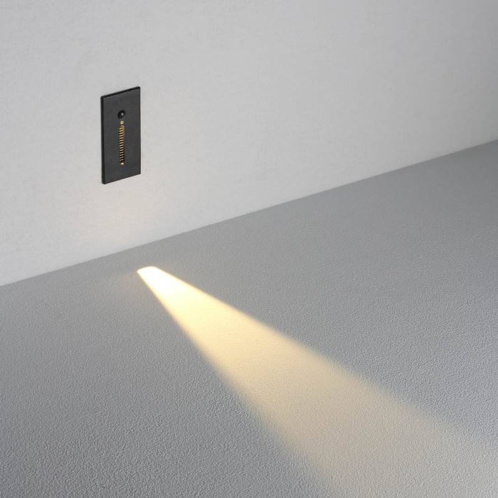 black sensor light for the stairs installed on a white wall