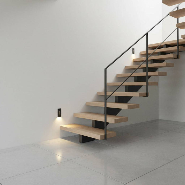 black sensor light for the stairs installed in the wall of a modern staircase