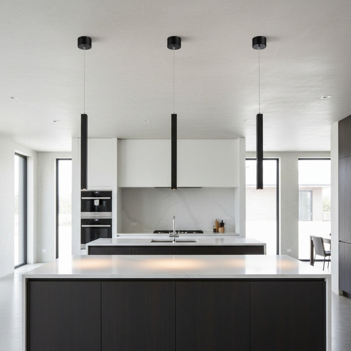 black slimline hanging pendant light mounted in a row over a kitchen island