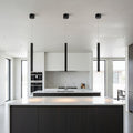 black slimline hanging pendant light mounted in a row over a kitchen island