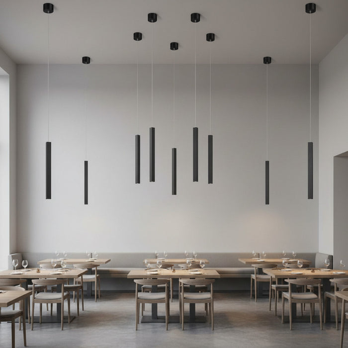 black slimline hanging pendant lighting mounted on a restaurant ceiling