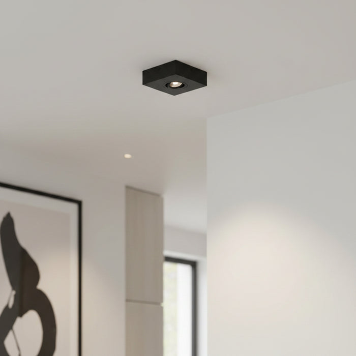 black slimline surface ceiling downlight mounted on the ceiling in a modern home