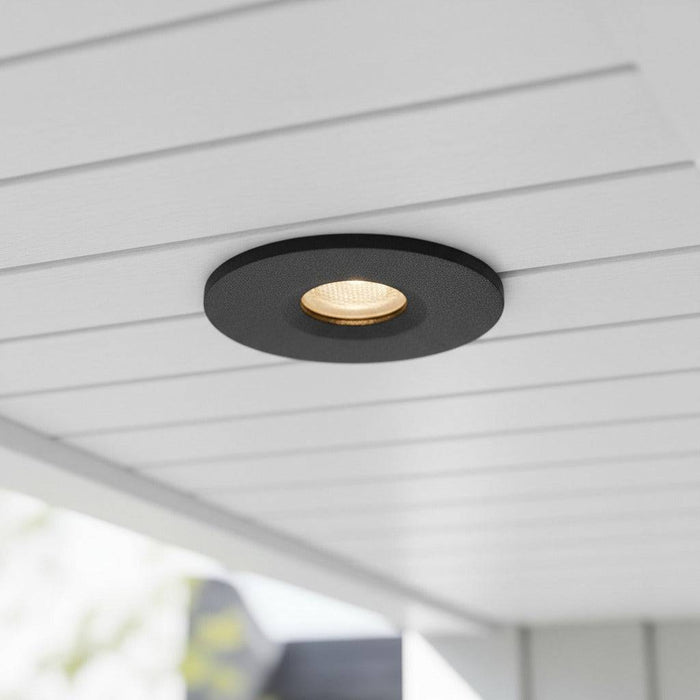 black small outdoor downlight mounted under the soffit of a modern home