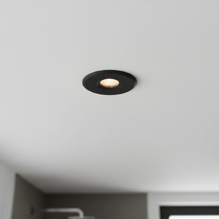black waterproof recessed bathroom ceiling light installed in a modern bathroom